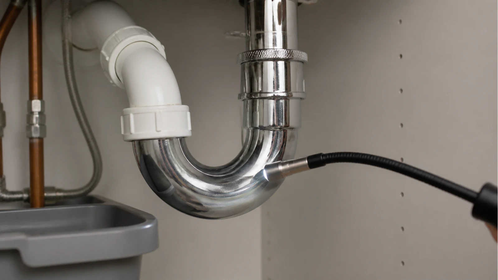 Articulating inspection camera tip navigating a domestic U-bend under a sink